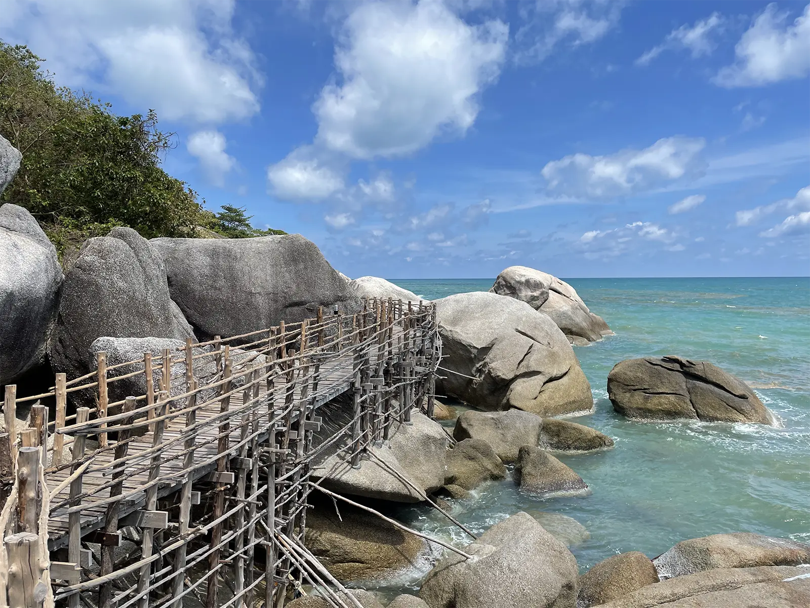 Bamboo bridge over rocks and turquoise sea Haad Yuan Koh Phangan