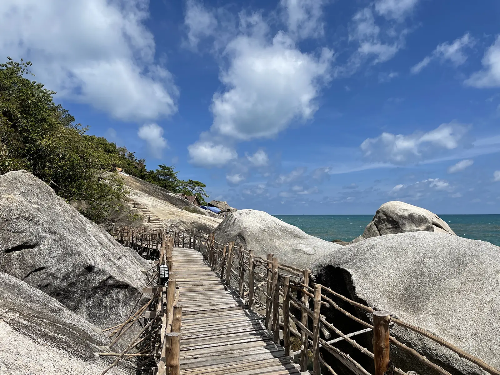 Wooden bridge on rocks Haad Yuan beach Koh Phangan