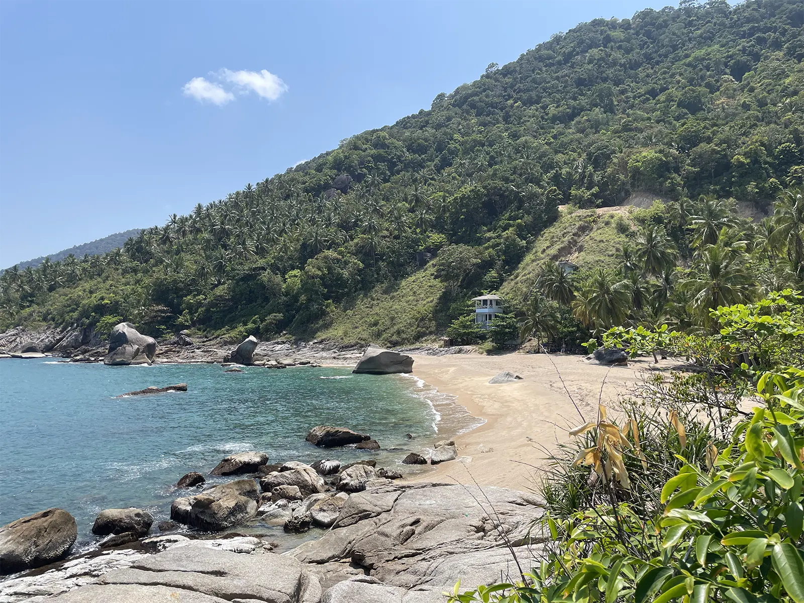 Wild secluded cove Koh Phangan jungle granite rocks turquoise sea
