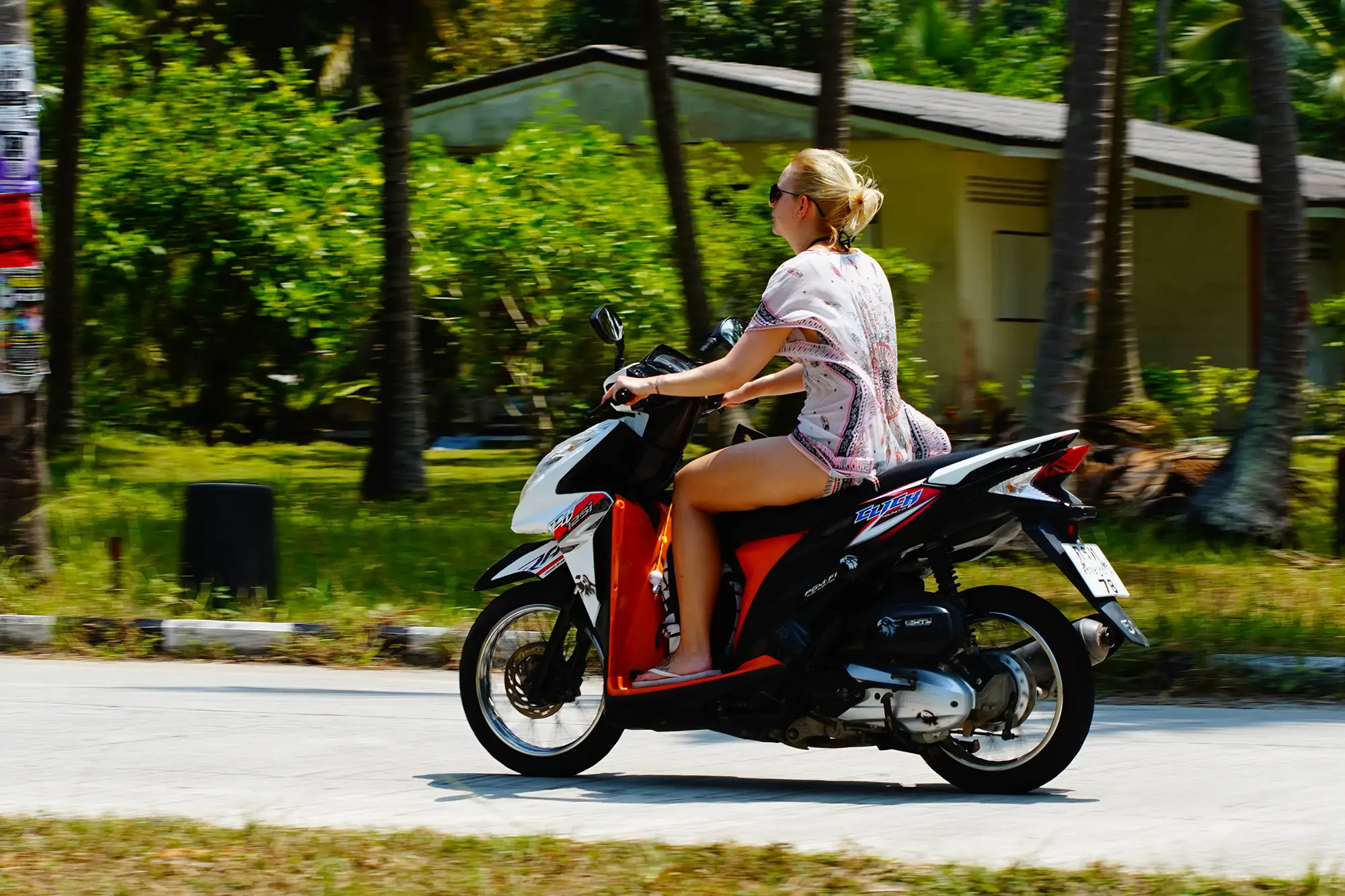 Scooter riding along a road in Koh Phangan